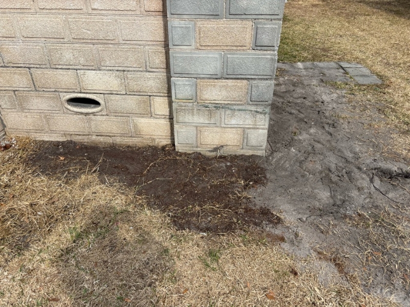 Soil backfilled and graded around stabilized front porch foundation after front porch repair work in St. Augustine, FL.