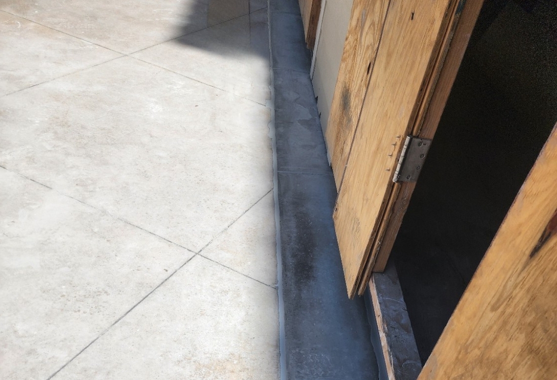 Restored patio slab after exterior waterproofing restoration in Fernandina Beach, FL, with protected membrane system installed.