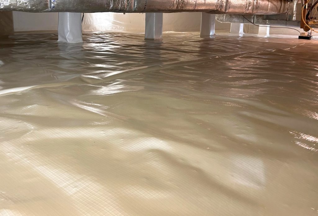 Encapsulated crawl space with white vapor barrier liner installed in a Florida home to prevent moisture and mice entry.