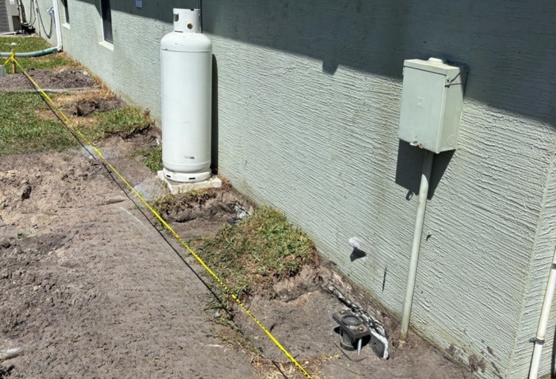 Installed push pier bracket with hydraulic jack at foundation footing after installation in Palm Coast, FL.