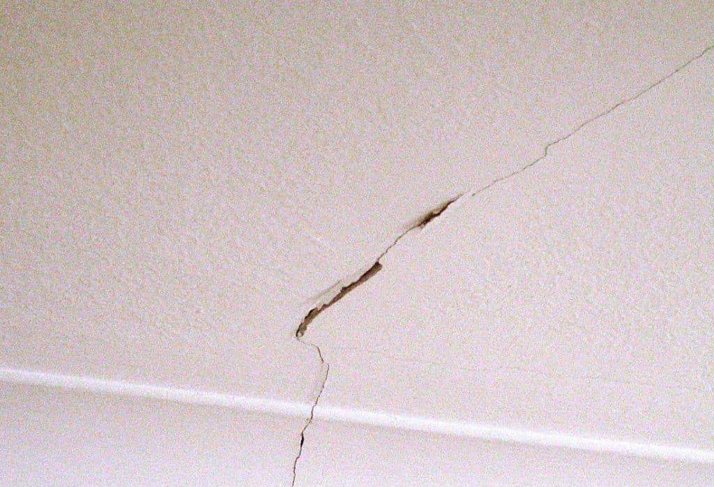 Diagonal ceiling crack in a Florida home showing widening displacement at the center, indicating possible foundation settlement.