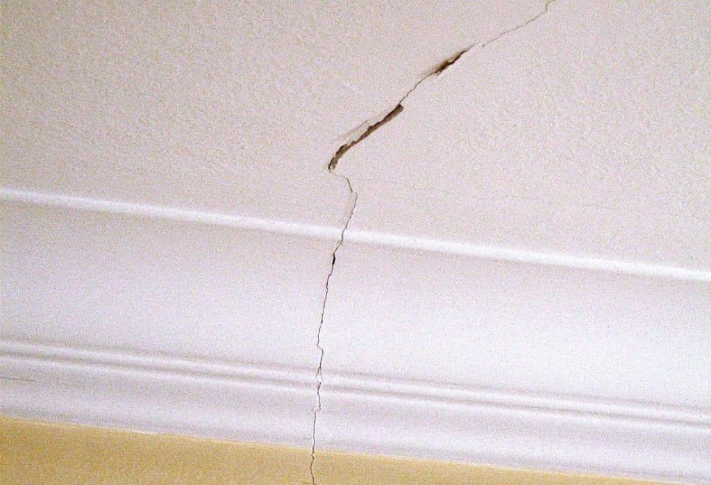 Close-up of a ceiling crack in a Florida home running vertically with visible widening near the top, showing a common ceiling issue.