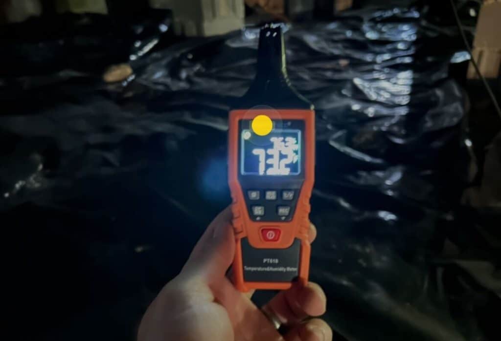 Humidity meter showing elevated moisture levels in crawl space requiring dehumidifier installation in St Augustine, FL.