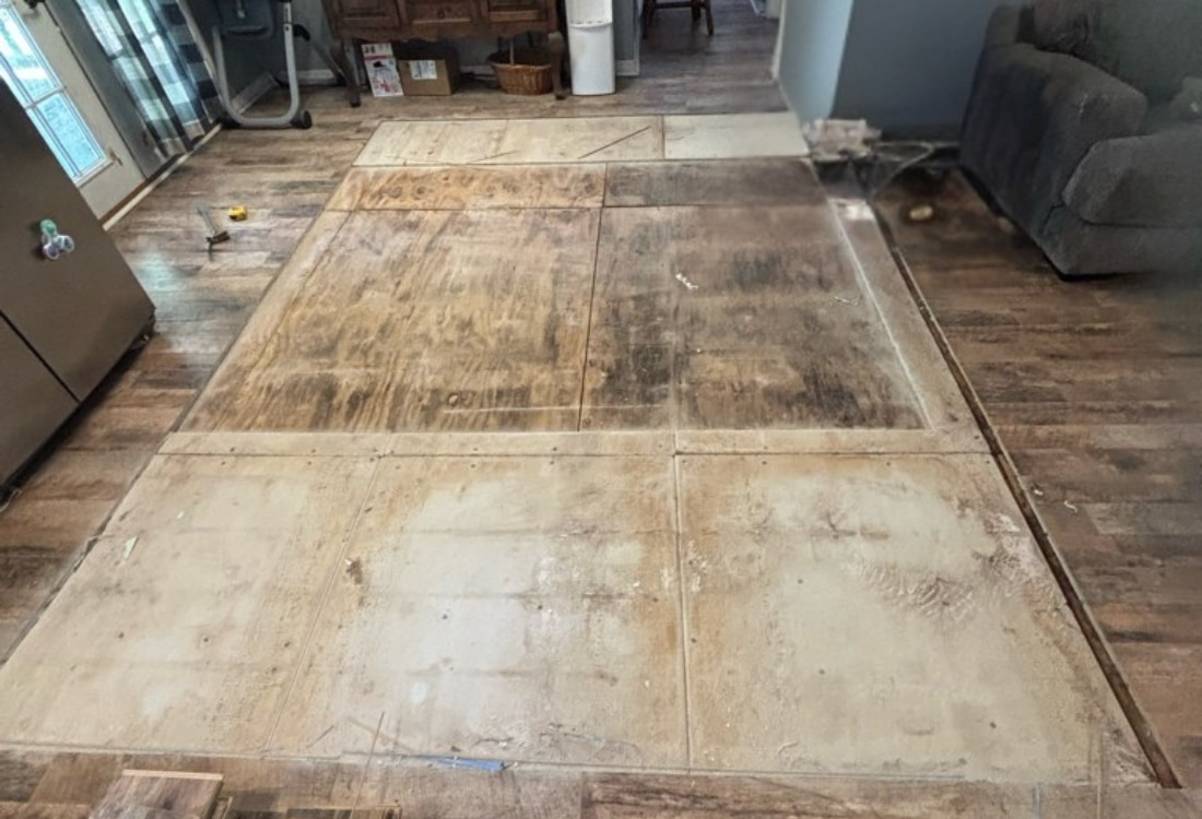 New sub-floor panels installed with crawl space support post after sagging floor repair in Callahan, FL.