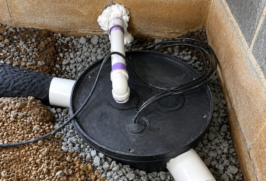Crawl space sump pump drainage system installed with discharge pipe protecting Palm Coast, FL, home foundation from standing water.