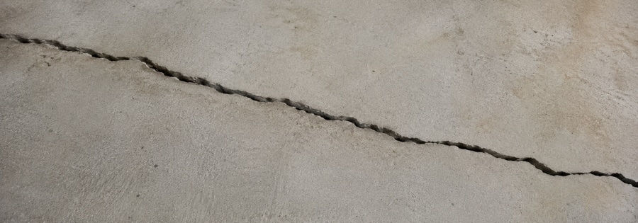 Long diagonal crack running across home's concrete slab floor, type of foundation cracks in Jacksonville Beach, FL, from shifting.