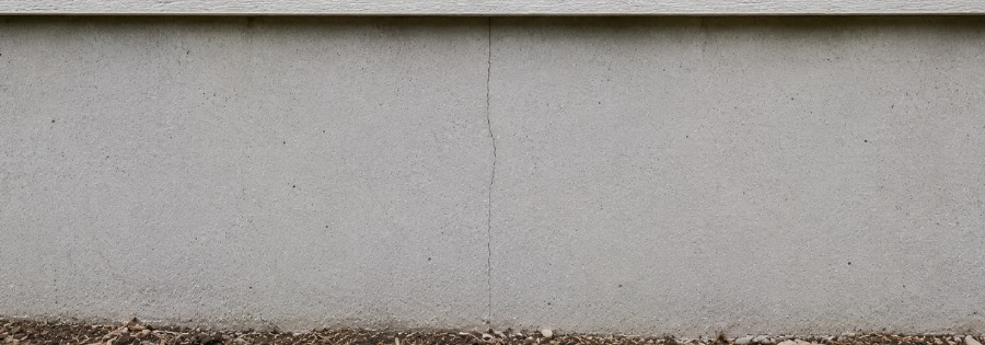 Thin hairline crack on a home's concrete foundation wall, often a minor concern type of foundation cracks in Ocala, FL.