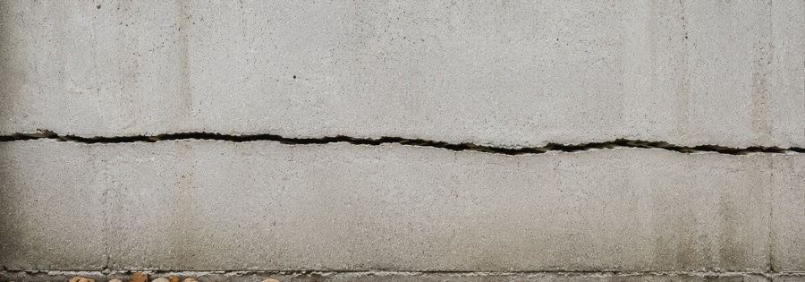 Thin hairline crack on a home's concrete foundation wall, often a minor concern type of foundation cracks in Ocala, FL.