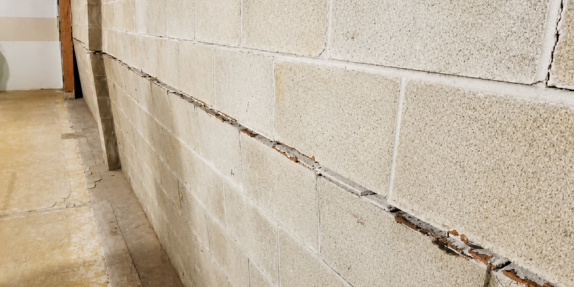 Severely bowing concrete foundation wall with cracking needing bowed foundation wall repair in Northern Florida.