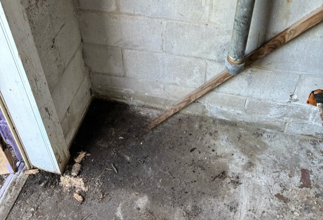 Sinking foundation laundry room interior before foundation repair helical pier installation in Neptune Beach, FL.