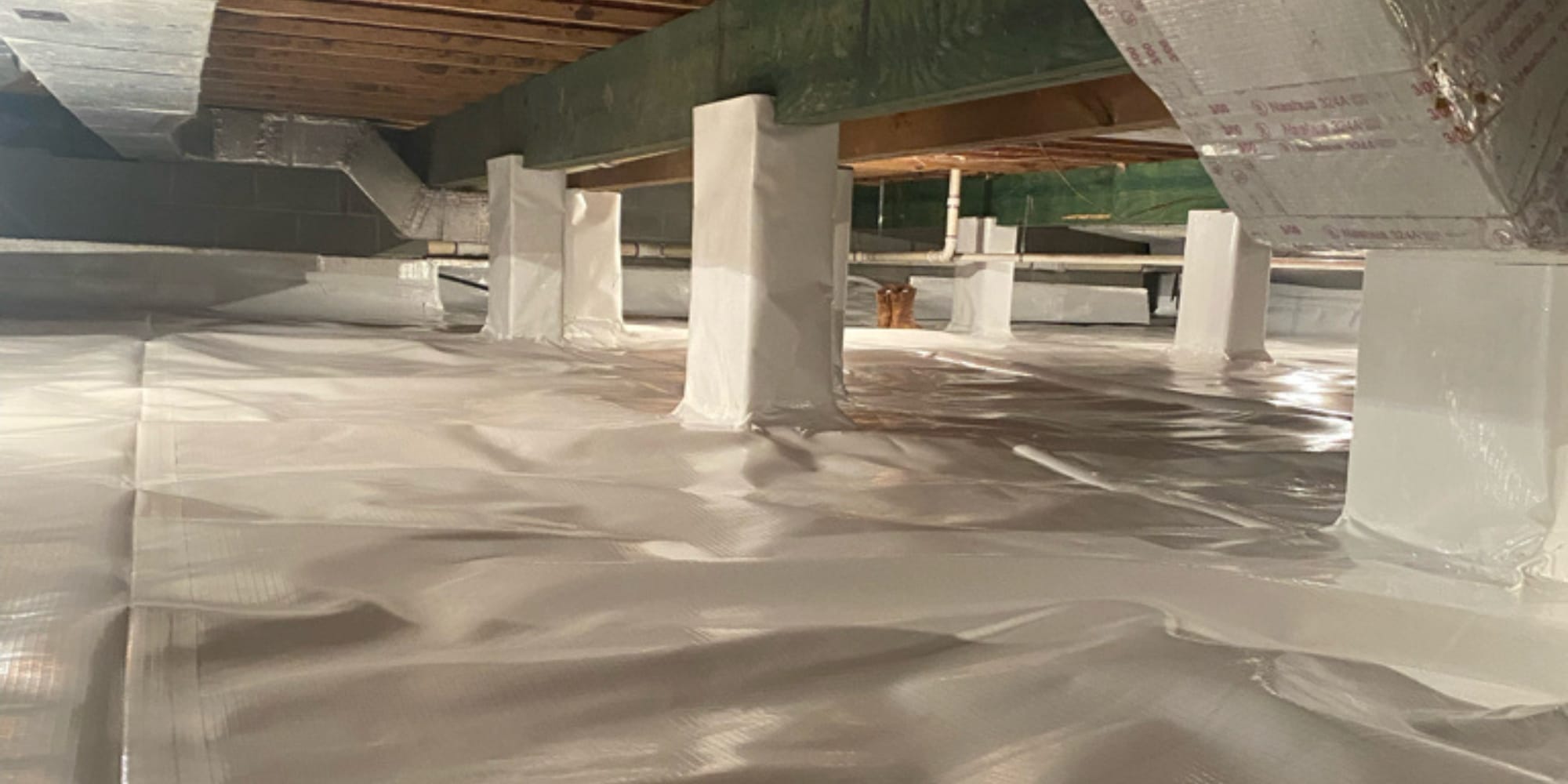 Sealed crawl space with vapor barrier showing moisture control and encapsulation, a benefit of sealing crawl space in Northern Florida.