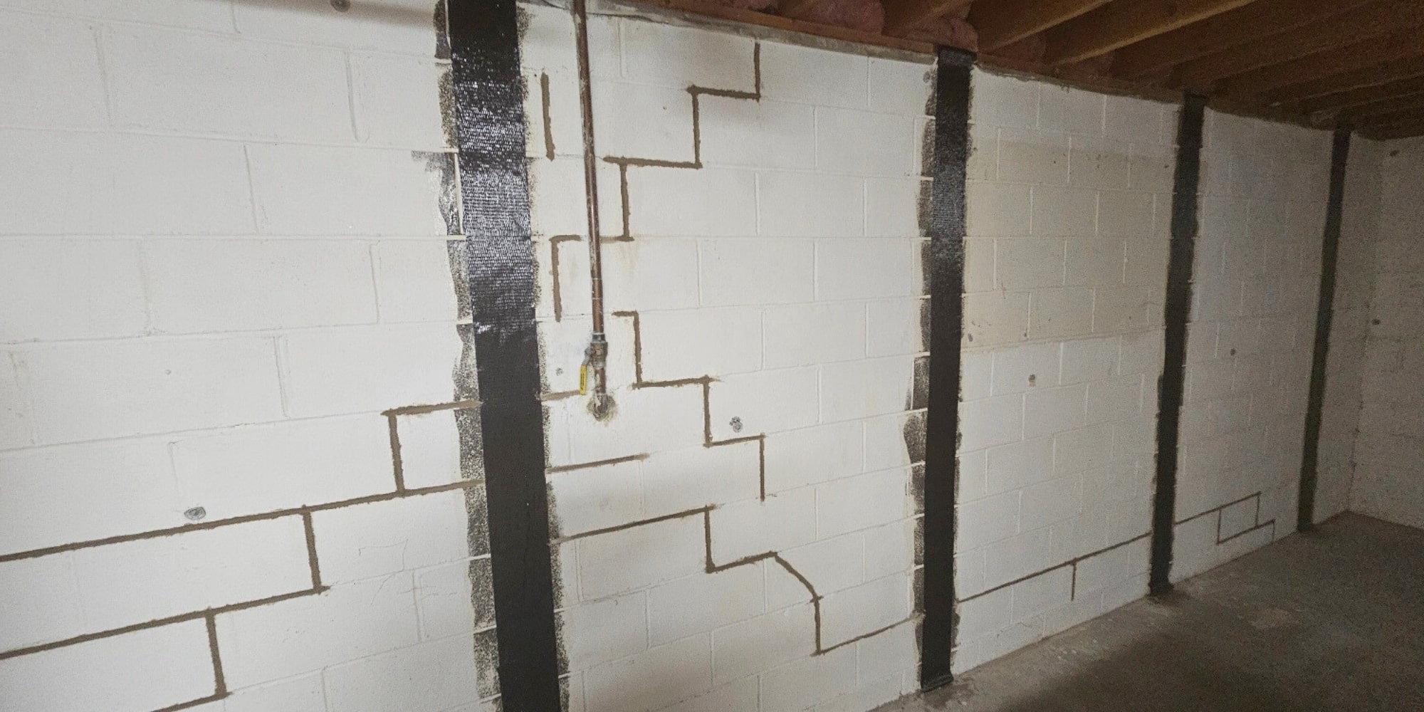 Carbon fiber straps stabilized cracked foundation wall, showing worthy carbon fiber foundation repair cost in Northern Florida.