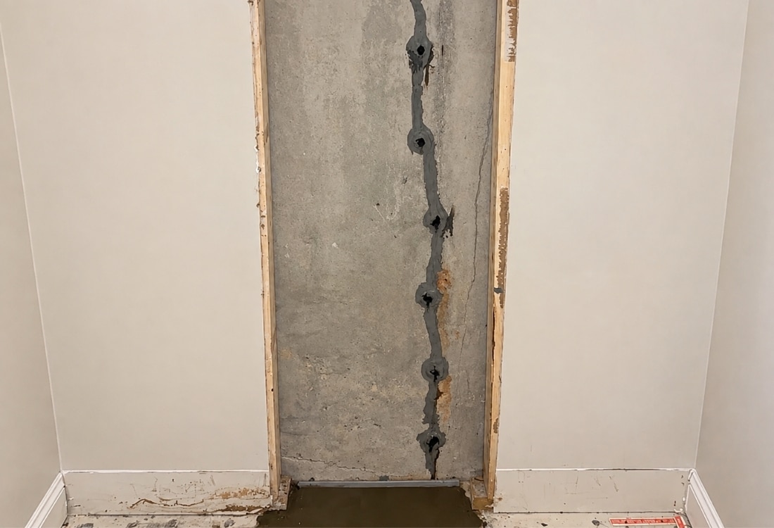 Vertical foundation wall crack with epoxy injection in the entire crack length during fixing foundation crack in St Augustine, FL.