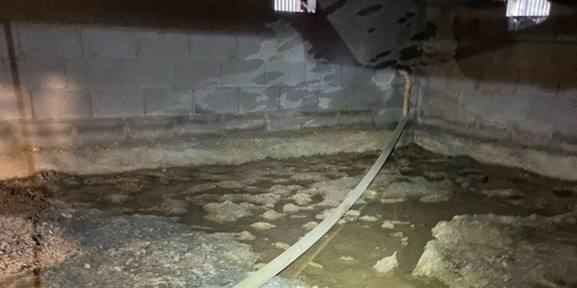 Standing water pooling in a crawl space, the root cause that needs to be solved to prevent crawl space mold in Northern FL.