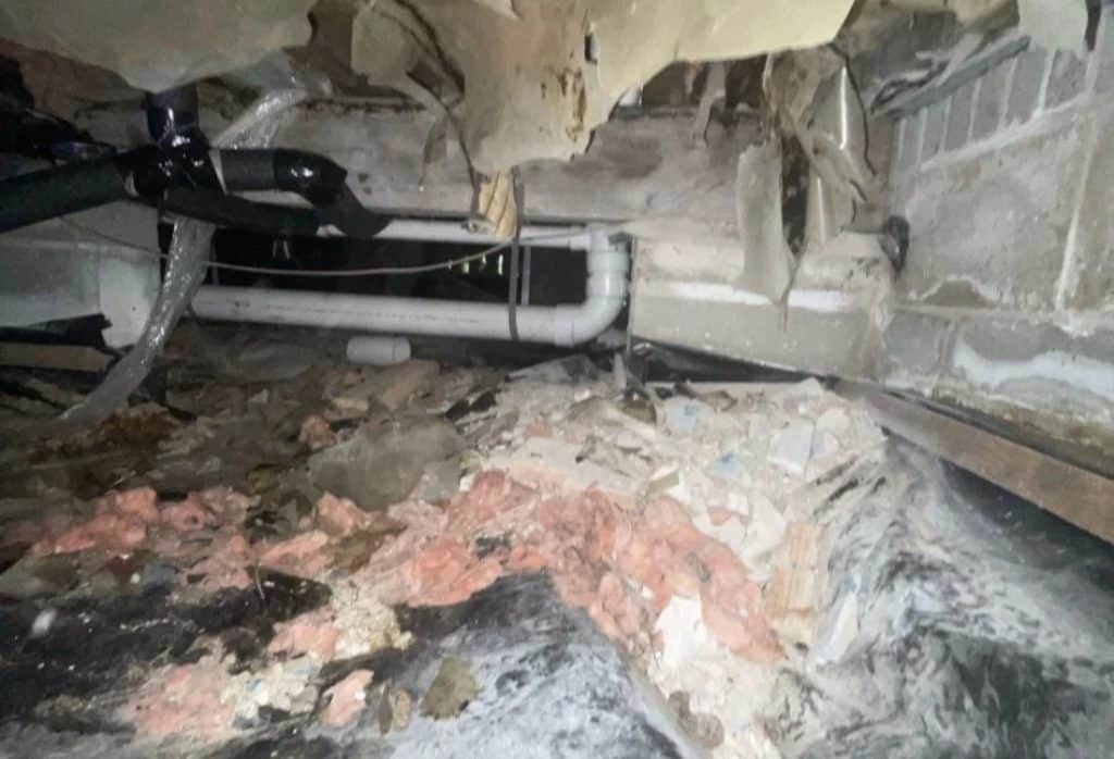 Torn insulation and debris found during a crawl space inspection checklist review, a sign of prolonged moisture in Jacksonville, FL.